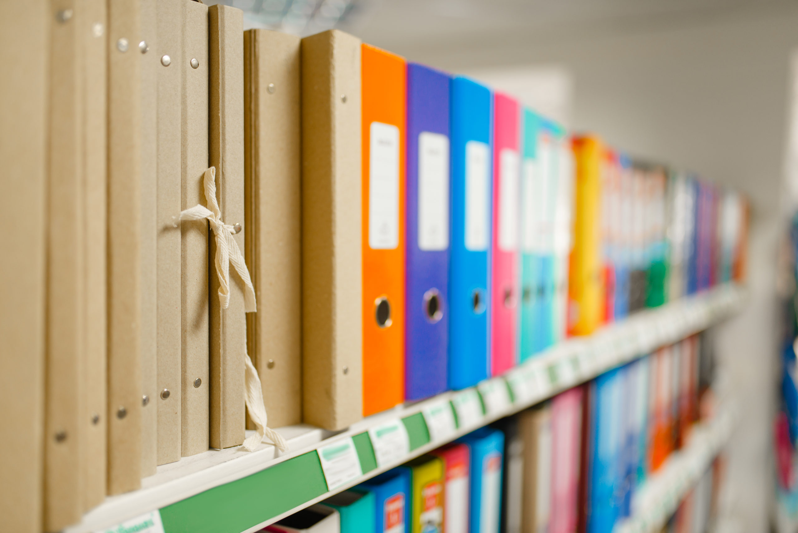 Shelf with folders in stationery store, nobody Shelf with folders in stationery store, nobody. Office supplies assortment in shop, rows of accessories for drawing and writing, school equipment